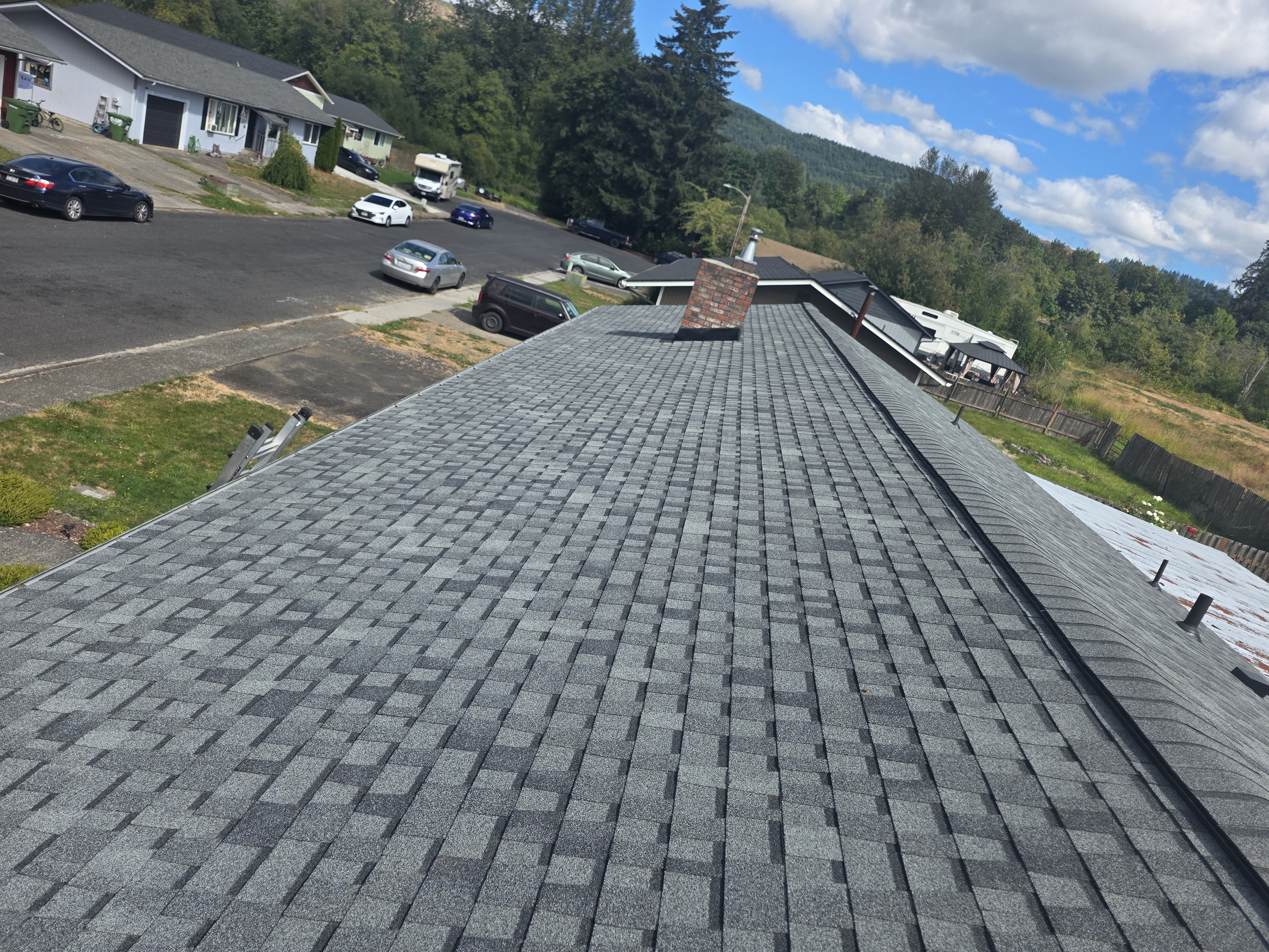 New architectural shingle roof installed by TK Construction & Roofing