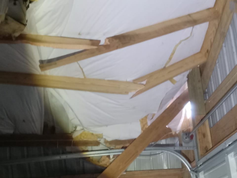 Broken garage roof rafters before TK Construction rebuilt them