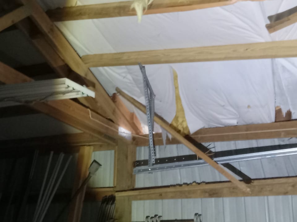 Interior garage roof leak damage before TK Construction repair