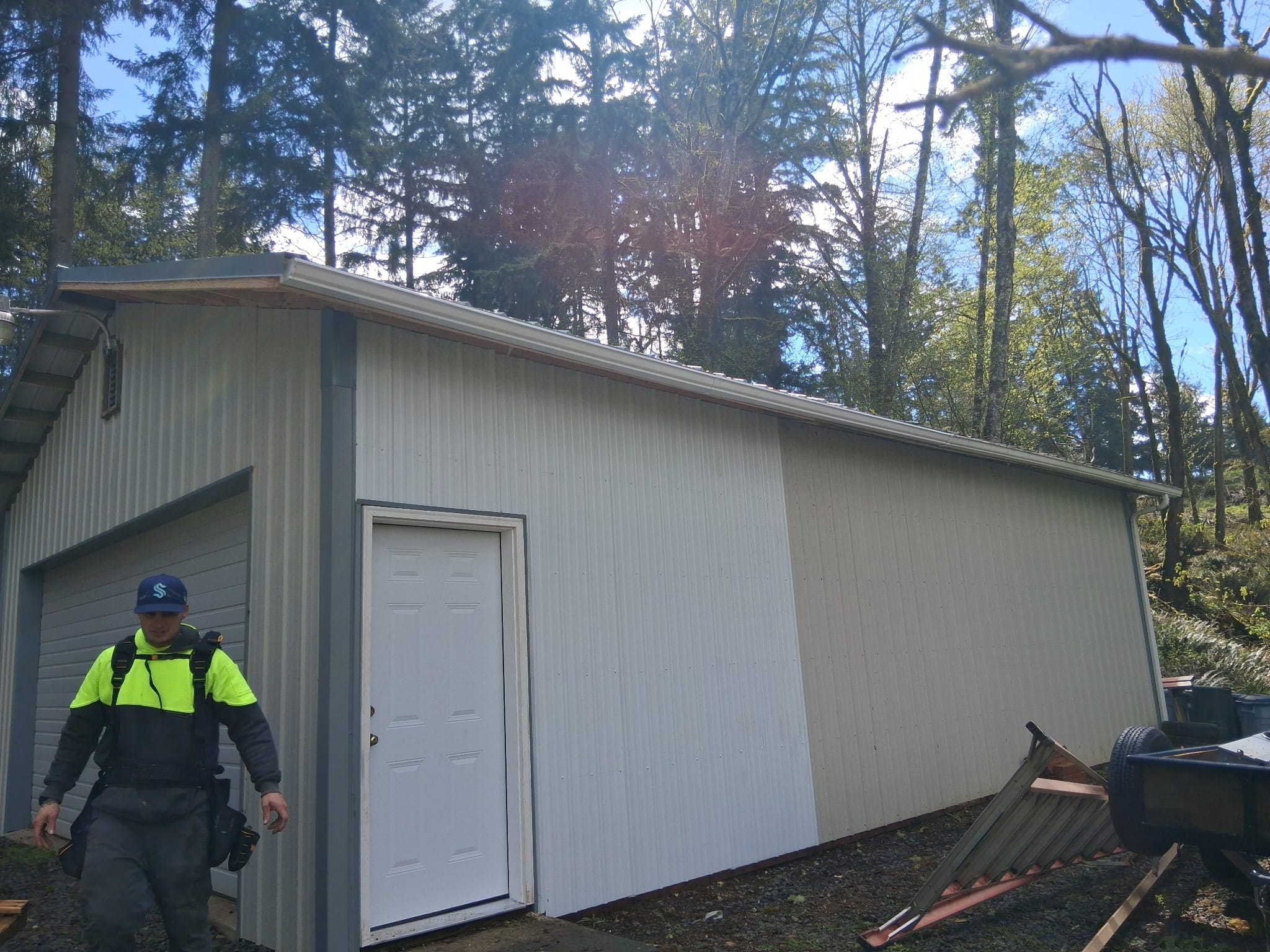 Metal roof and siding rebuilt after storm damage in a wooded Southwest Washington setting