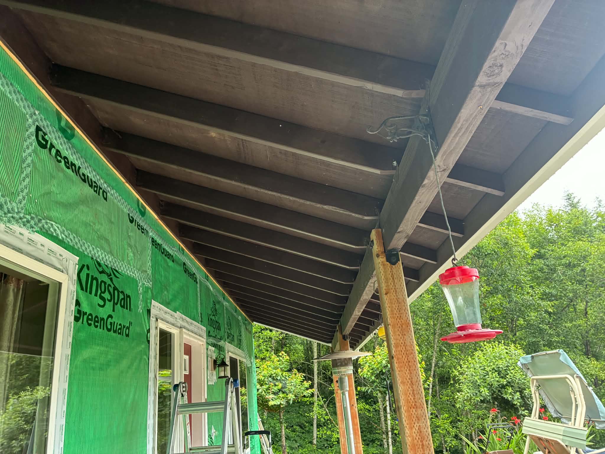 Exposed porch rafters and house wrap before the new soffit went on
