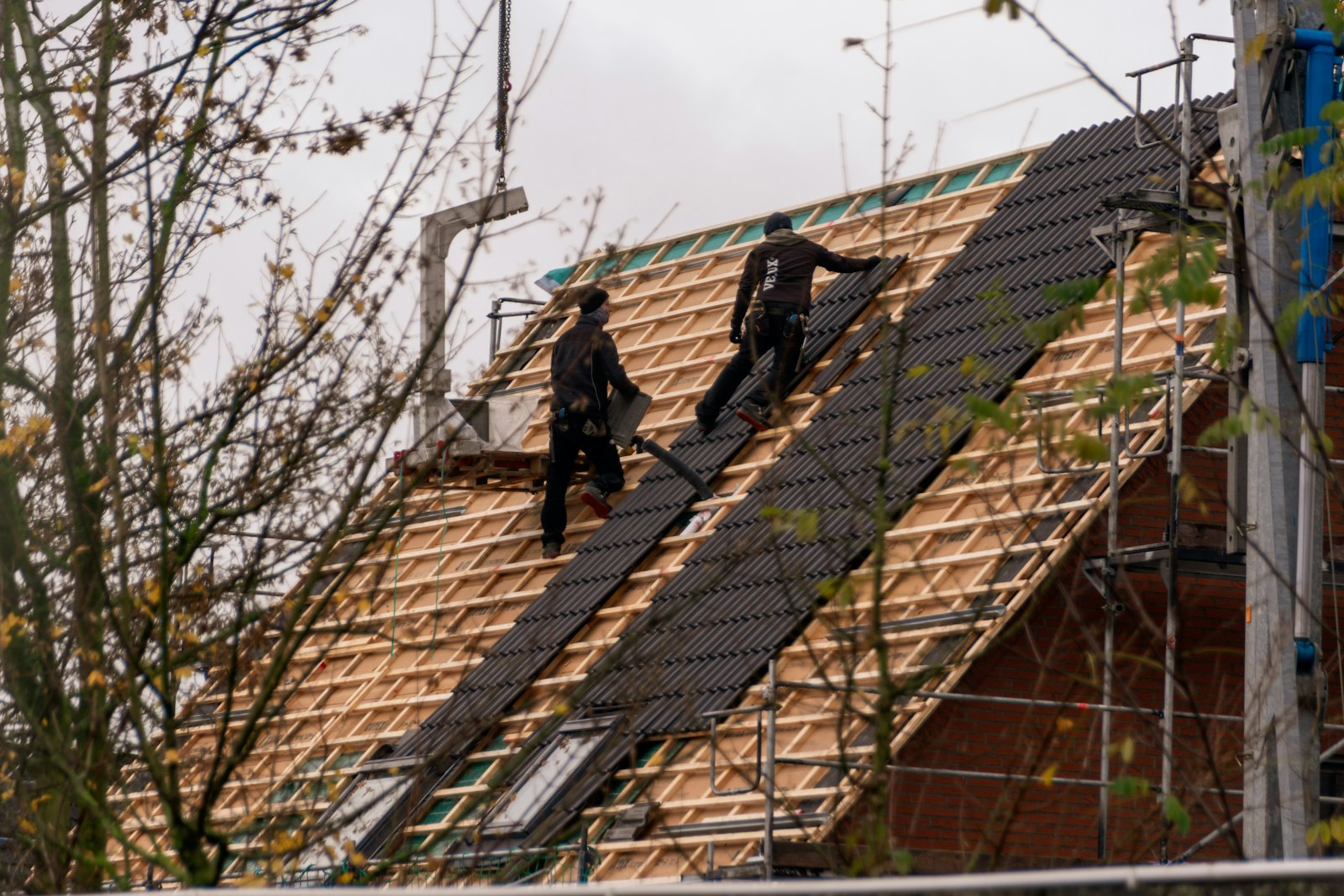 TK Construction & Roofing crew on a residential roof