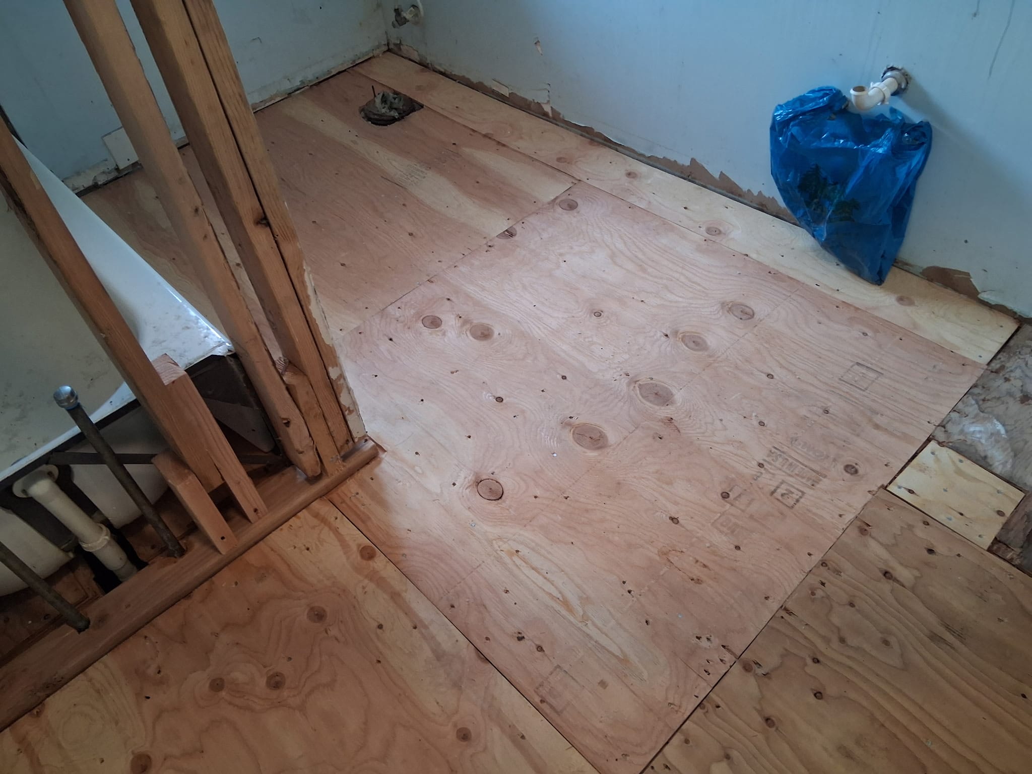 New plywood subfloor installed during an interior flooring repair